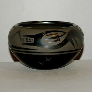 Avanyu design on a black on black jar