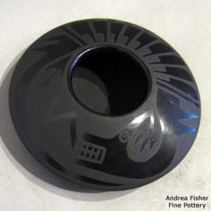 Feather and avanyu design on a black on black flying saucer jar