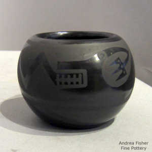Avanyu and thundercloud design on a black on black jar