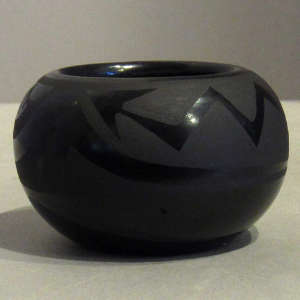 Avanyu design on a black on black jar