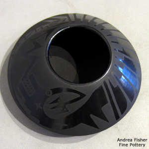 Feather and avanyu design on a black on black jar