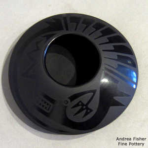 Feather, avanyu and geometric design on a black on black flying saucer jar