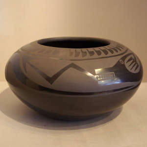 Avanyu and feather design on a black on black jar
