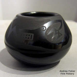 Avanyu and geometric design on a black on black jar