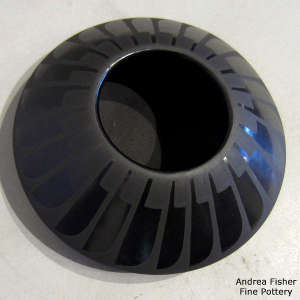 Ring of feathers on a black on black jar