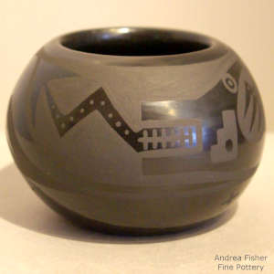 An avanyu and geometric design on a black on black jar