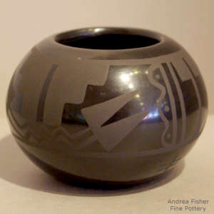 Feather and kiva step design on a black on black jar