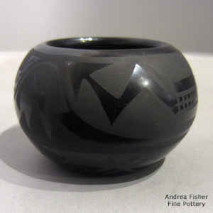 An avanyu design on a black on black bowl