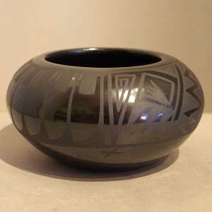 Feather and geometric design on a black on black jar