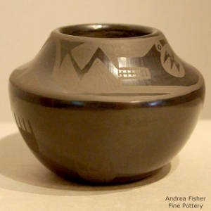 Avanyu and bear paw design on a black on black jar