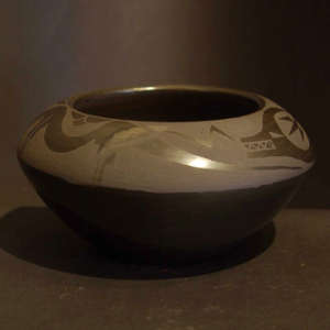 Avanyu design on a black on black jar