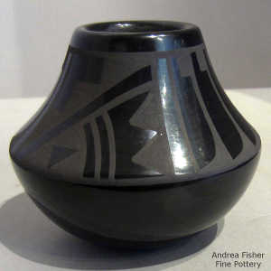 Feather and geometric design on a black on black jar