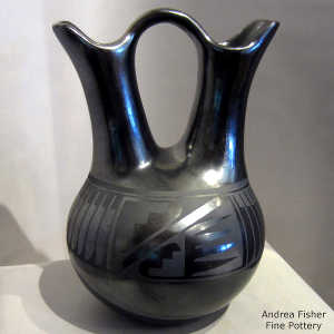 Feather and geometric design on a black on gunmetal black wedding vase