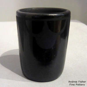 Cloud and geometric design on a black on black jar