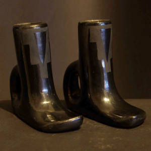 Pair of boot-shaped black on black candlestick holders