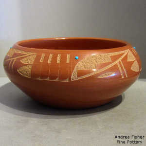 Sgraffito kiva step and feather design outside, micaceous slip inside this red bowl