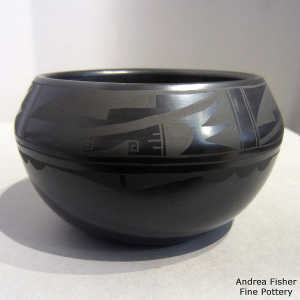 Micaceous slip inside and geometric design outside on a black on black bowl