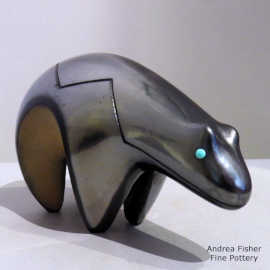Gunmetal black bear figure with carved heart lines and inlaid turquoise eyes
