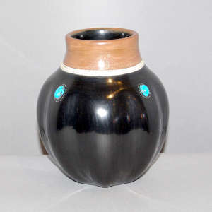 Inlaid stones and sgraffito geometric design on a black melon jar with a sienna rim