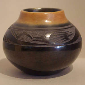 Sgraffito avanyu design and sienna rim on a polished black jar