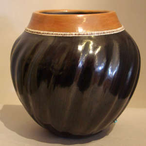 Heishe and sienna rim plus one piece of inlaid turquoise on a highly polished black swirl melon jar