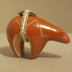 Click to see a larger version Heishe and arrowhead with inlaid turquoise on a polished red bear