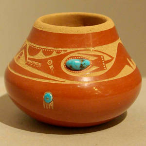 Inlid turquoise and sgraffito avanyu and bear paw design on a red jar