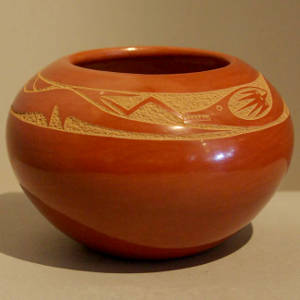 Sgraffito avanyu design on a red jar