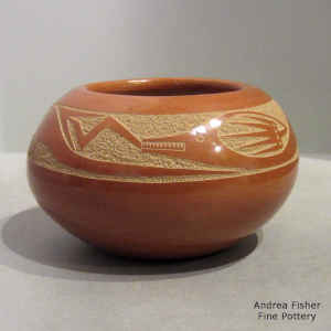 Sgraffito avanyu design on a red jar