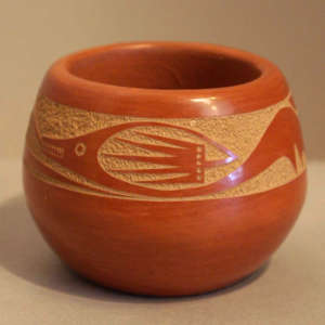 Sgraffito avanyu design on a red bowl