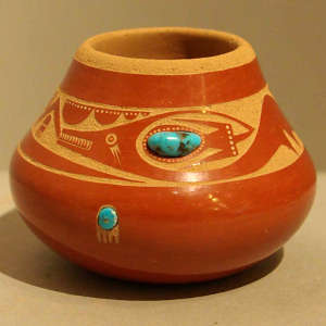 Sgraffito avanyu and bear paw design with two pieces of inlaid turquoise on a polished red jar