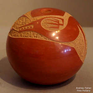 Sgraffito avanyu design on a red seed pot