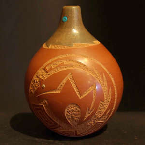 Sgraffito geometric design with inlaid turquoise and coral on a red and brown jar