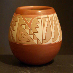 Sgraffito and painted geometric designs in a band around a polychrome jar