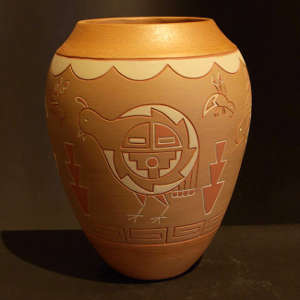 Lightly carved bear, birds, bugs and geometrics on a polychrome jar