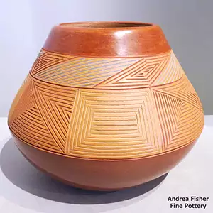 Red-on-red Potsuwii bowl with a fine line geometric design etched above the shoulder