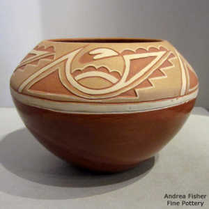 Lightly carved kiva step, rising sun, clouds, lightning bolt and geometric design on a red jar