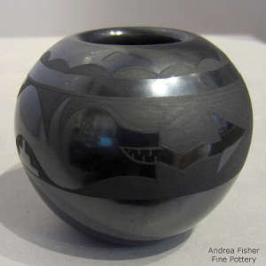 Avanyu and geometric design on a black on black jar