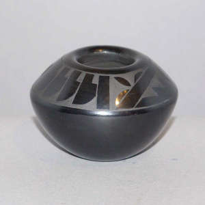 Feather, kiva step and geometric design on a black on black jar