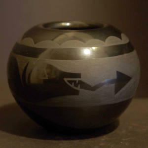 Avanyu and cloud design on a black on black jar