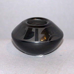 Feather and cloud design on a black on black jar