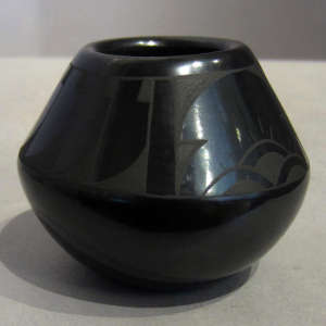 Feather, cloud and geometric design on a black on black jar