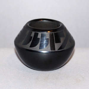 Feather and geometric design on a black on black jar