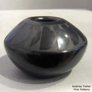 Feather design on a black on black jar