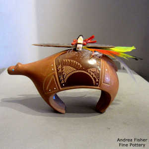 Mixed media bear-shaped piece with polished red sgraffito geometric design and red micaceous slip plus feathers