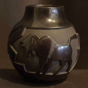 Bison and ram design carved into a black jar