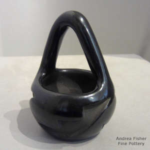 Kiva step and geometric design carved into a black bowl with a handle