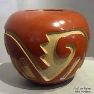 Geometric design carved into a red jar