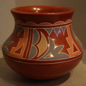 Polychrome geometric designs on a polished red jar