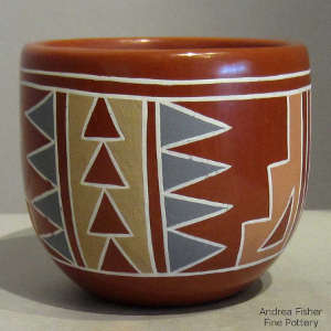 Multi-color geometric design on a polished red jar